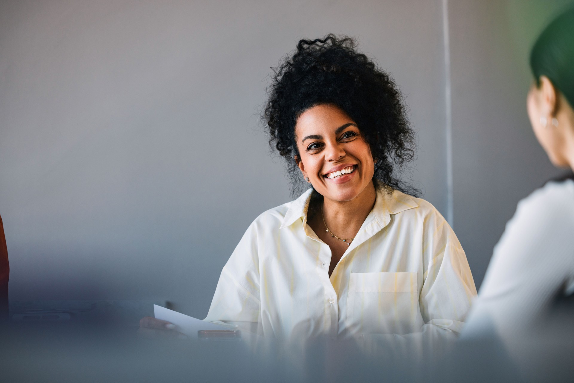 Smiling Businesswoman Engaged in a Productive Meeting Discussion with a Colleague